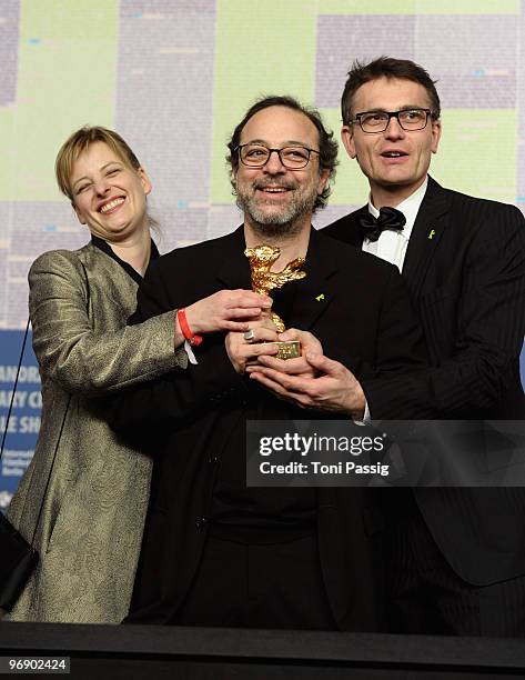 Co-producer Bettina Brokemper, director Semih Kaplanoglu and co-producer Johannes Rexin pose with the Golden Bear Award for Best Film at the 'Award...