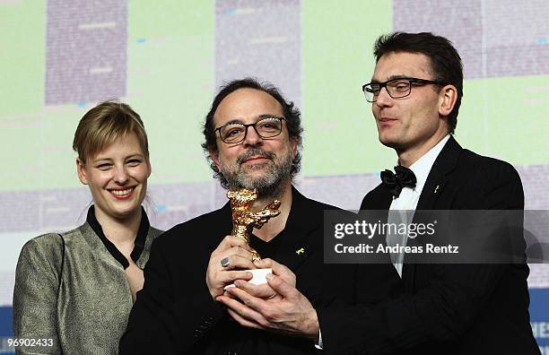 Co-producer Bettina Brokemper, director Semih Kaplanoglu and co-producer Johannes Rexin pose with the Golden Bear Award for Best Film at the 'Award...