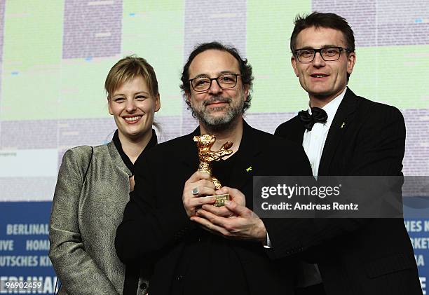 Co-producer Bettina Brokemper, director Semih Kaplanoglu and co-producer Johannes Rexin pose with the Golden Bear Award for Best Film at the 'Award...