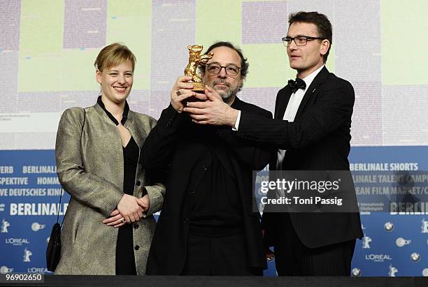 Co-producer Bettina Brokemper, director Semih Kaplanoglu and co-producer Johannes Rexin pose with the Golden Bear Award for Best Film at the 'Award...