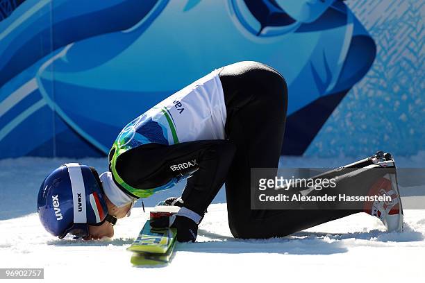 Adam Malysz of Poland kisses the snow covered ground after jumping the Large Hill on day 9 of the 2010 Vancouver Winter Olympics at Ski Jumping...