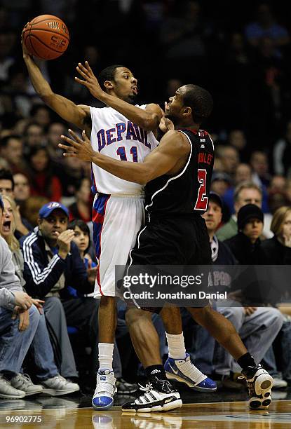 Jeremiah Kelly of the DePaul Blue Demons tries to pass under pressure from Preston Knowles of the Louisville Cardinals at the Allstate Arena on...