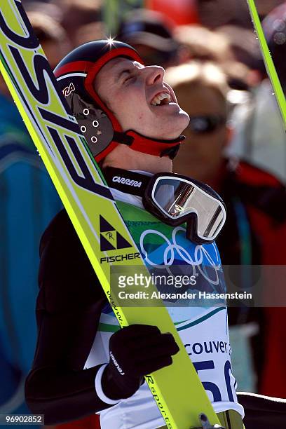 Simon Ammann of Switzerland celebrates after coming to a landing after the final jump the Large Hill on day 9 of the 2010 Vancouver Winter Olympics...