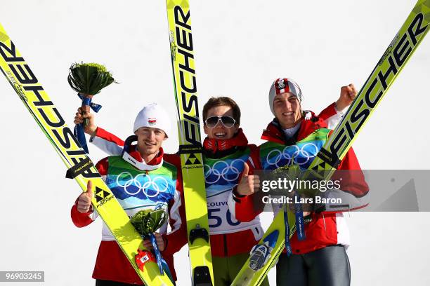 Simon Ammann of Switzerland celebrates his Gold medal, Adam Malysz of Poland Silver and Gregor Schlierenzauer of Austria Bronze after the final jump...