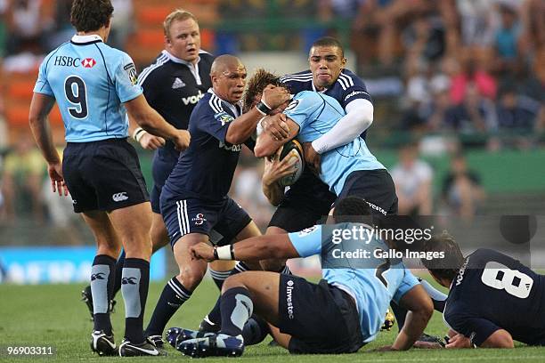 Ricky Januarie and Bryan Habana from the Stormers tackle Lachie Turner from the Waratahs during the Super 14 match between Stormers and Waratahs at...