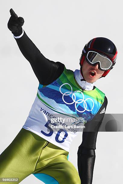 Simon Ammann of Switzerland celebrates after coming to a landing after the final jump the Large Hill on day 9 of the 2010 Vancouver Winter Olympics...