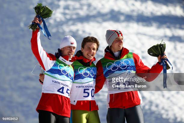 Simon Ammann of Switzerland celebrates his Gold medal, Adam Malysz of Poland Silver and Gregor Schlierenzauer of Austria Bronze after the final jump...