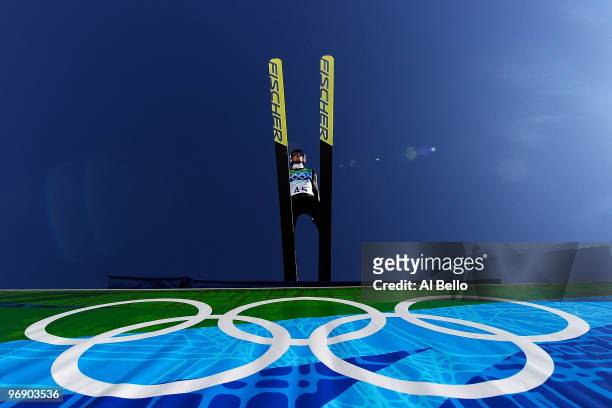 Adam Malysz of Poland soars off the Large Hill on the final jump on day 9 of the 2010 Vancouver Winter Olympics at Ski Jumping Stadium on February...