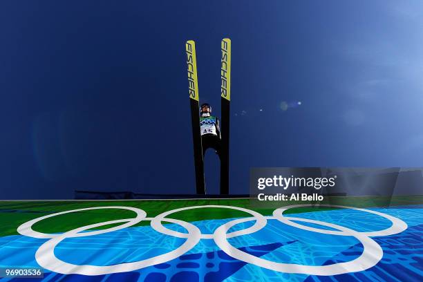 Adam Malysz of Poland soars off the Large Hill on the final jump on day 9 of the 2010 Vancouver Winter Olympics at Ski Jumping Stadium on February...