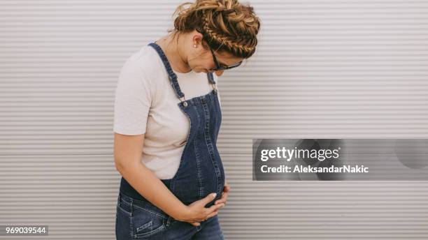 portrait of a pregnant woman - bib overalls stock pictures, royalty-free photos & images