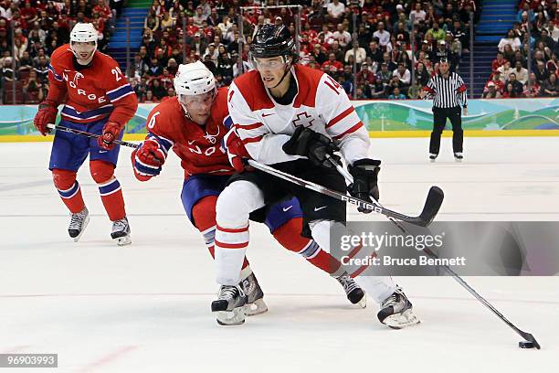 Jonas Holos of Norway and Roman Wick of Switzerland battles for the puck during the ice hockey men's preliminary game between Norway and Switzerland...