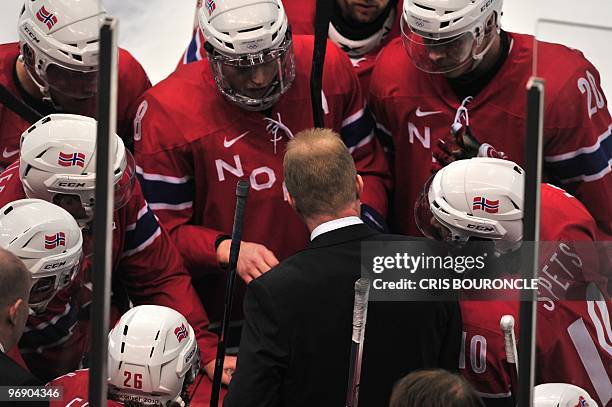 Norway's coach Roy Johansen speaks to his team during the Men's preliminary Ice Hockey match Norway against Switzerland at the XXI Winter Olympic...