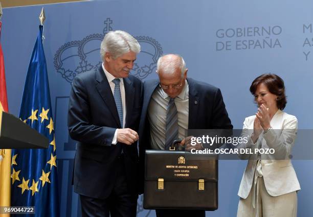 The new Spanish minister of foreign affairs Josep Borrell and former minister of foreign affairs Alfonso Dastis pose beside the new Deputy Prime...