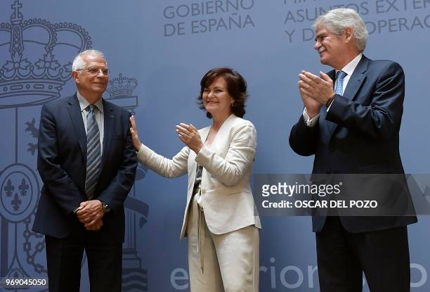 The new Spanish minister of foreign affairs Josep Borrell stands beside former minister of foreign affairs Alfonso Dastis and the new Deputy Prime...
