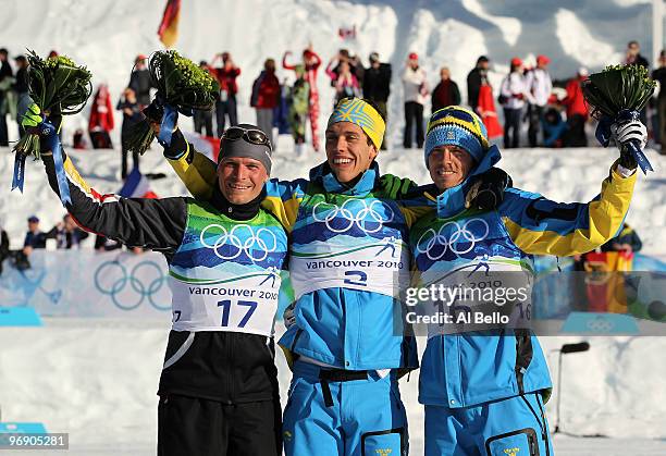 Marcus Hellner of Sweden on the podium after winnning the Gold medal along with Tobias Angerer of Germany who won the Silver, and Johan Olsson of...