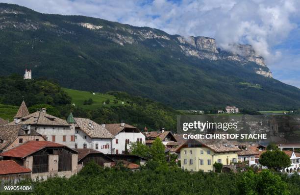Picture taken on June 6, 2018 shows a partial view of the small village and the Heilig-Kreuz-Kirche of St. Michael Eppan, South Tyrol, northern...
