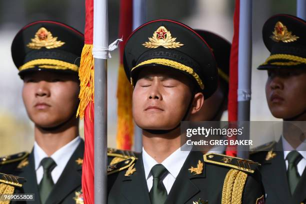 Flag bearers prepare for a welcome ceremony for Kazakhstan's President Nursultan Nazarbayev outside the Great Hall of the People in Beijing on June...