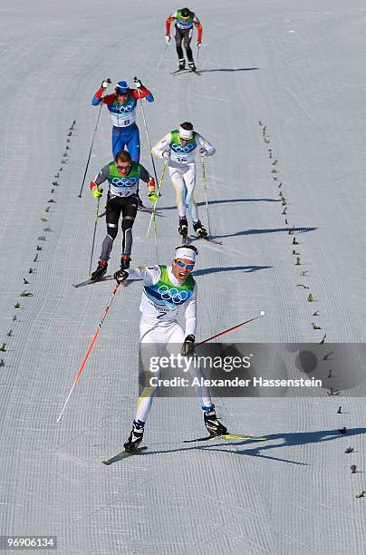 Marcus Hellner of Sweden celebrates as he approaches the finish line to win the Men's 30 km Pursuit on day 9 of the 2010 Vancouver Winter Olympics at...