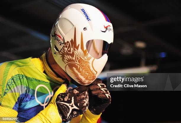 Kazuhiro Koshi of Japan removes his helmet after his final run in the Men's Skeleton on day 8 of the 2010 Vancouver Winter Olympics at the Whistler...