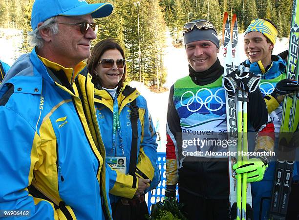 Swedish King Carl Gustaf and Swedish Queen Silvia interact with Tobias Angerer of Germany after he captured the Silver medal and Sweden's Marcus...
