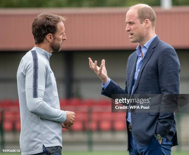 Prince William, Duke of Cambridge chats to England manager Gareth Southgate as he attends the Facility at the FA Training Ground to meet members of...