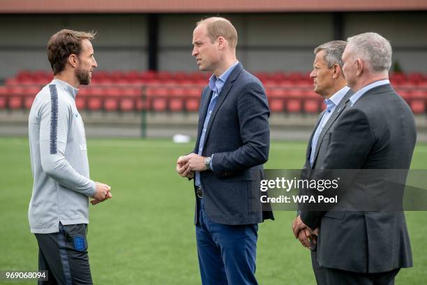 Prince William, Duke of Cambridge chats to England manager Gareth Southgate as he attends the Facility at the FA Training Ground to meet members of...