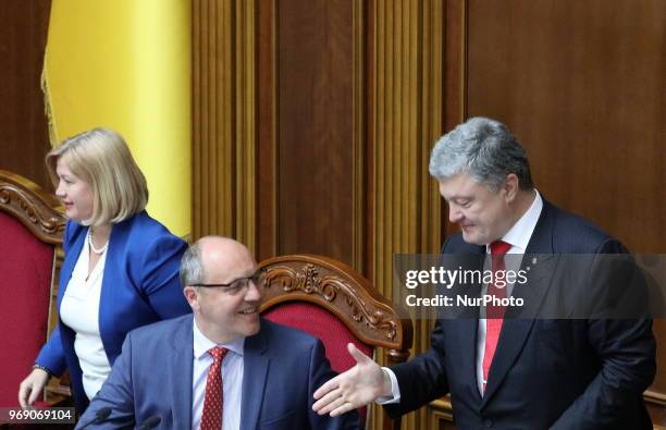 Ukrainian President Petro Poroshenko shakes hands with Parliament Speaker Andriy Parubiy after voting on a law to establish an anti-corruption court...