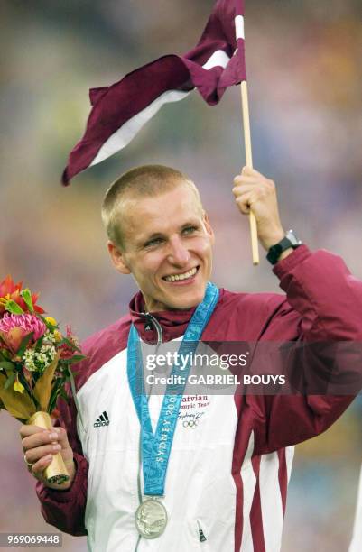 Aigars Fadejevs of Latvia waves the Lativan flag after taking the silver medal in the men's 50km walk final 29 September, 2000 at the Sydney Olympic...