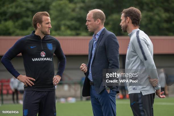 Prince William, Duke of Cambridge chats to England manager Gareth Southgate and Harry Kane as he attends the Facility at the FA Training Ground to...