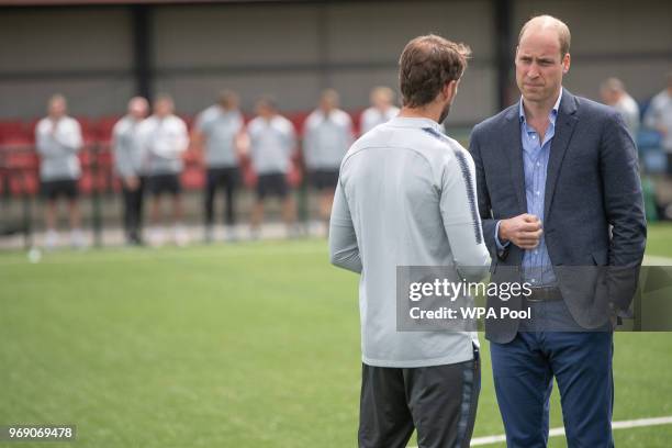 Prince William, Duke of Cambridge chats to England manager Gareth Southgate as he attends the Facility at the FA Training Ground to meet members of...