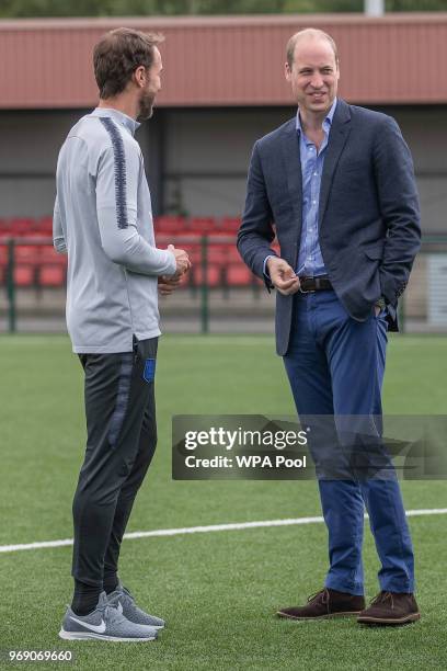 Prince William, Duke of Cambridge chats to England manager Gareth Southgate as he attends the Facility at the FA Training Ground to meet members of...