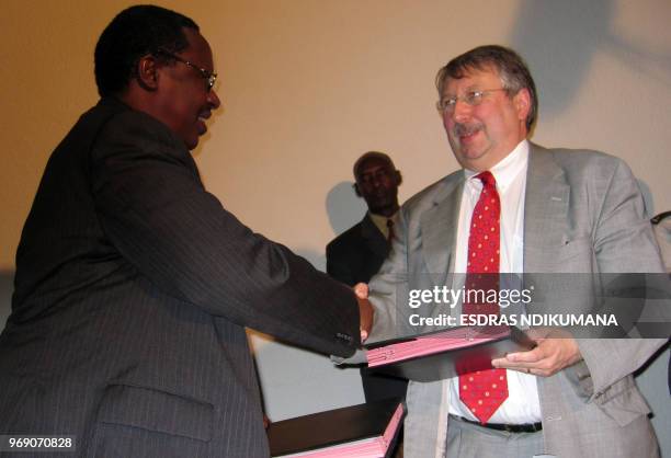 Burundi's Defence minister, General Vincent Nyungeko and his Belgian counterpart Andre Flahaut shake hands after signing a renewed co-operation...
