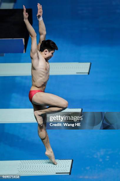 Cao Yuan of China competes in the men's 3m Synchro Springboard final on FINA Diving World Cup 2018 at the Wuhan Sports Center on June 7, 2018 in...