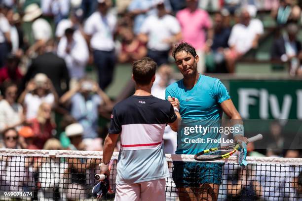 Diego Schwartzman of Argentina congratulates Rafael Nadal of Spain on victory following their mens singles quarter finals match during day twelve of...