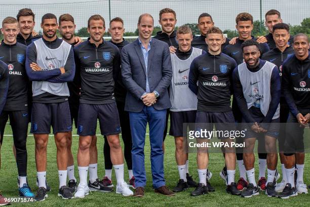 Prince William, Duke of Cambridge poses with the England players including Captain Harry Kane as he attends the Facility at the FA Training Ground to...