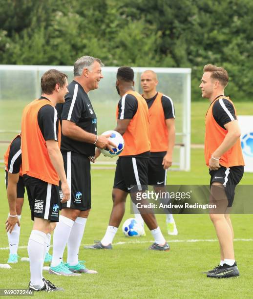 Sam Allardyce manager of England and Olly Murs in discussion as they take part in training during a Soccer Aid for UNICEF media session at Fulham FC...