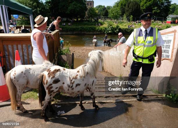 An RSPCA officer stands by the entrance ramp to the River Eden on the first day of the Appleby Horse Fair on June 7, 2018 in Appleby, England.The...