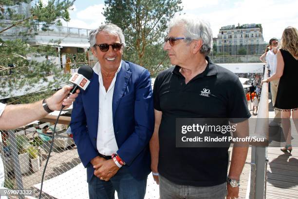 Actors Richard Anconina and Michel Boujenah answer to journalist during the 2018 French Open - Day Twelve at Roland Garros on June 7, 2018 in Paris,...