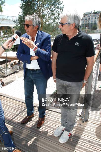 Actors Richard Anconina and Michel Boujenah answer to journalist during the 2018 French Open - Day Twelve at Roland Garros on June 7, 2018 in Paris,...