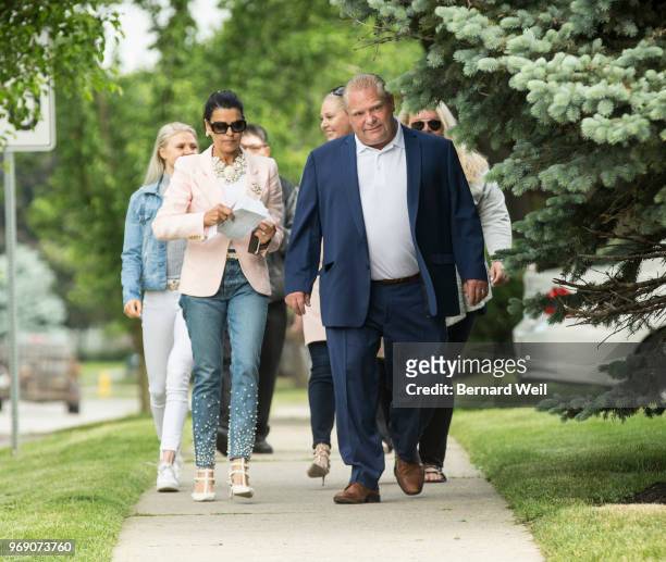 Ontario PC Leader Doug Ford walks with his wife Karla and family to St. George's Junior School Polling Station 28 in Etobicoke to cast his vote in...