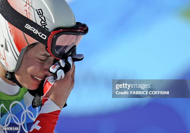 Swiss Dominique Gisin leaves the course in pain after crashing heavily during the Women's downhill event on February 17, 2010 at the Whistler...