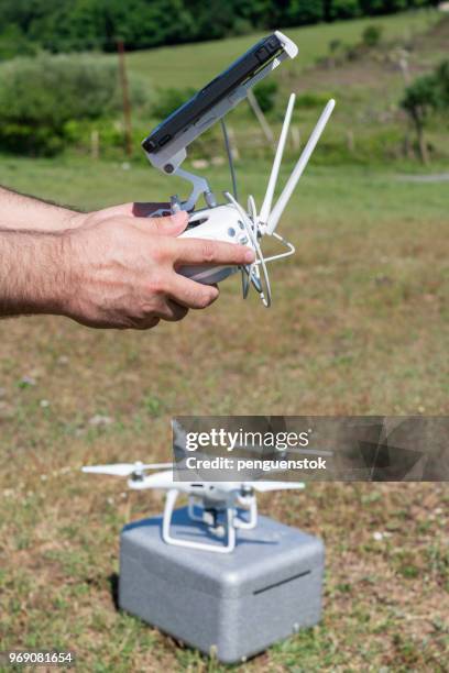 drone operator using a remote control. - pilot joystick stock pictures, royalty-free photos & images