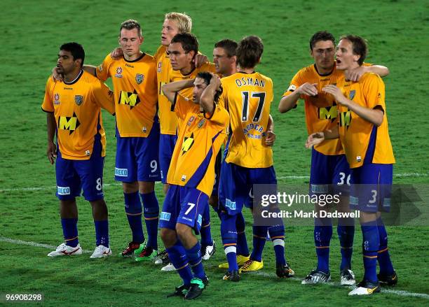 United players look on as Kristian Rees misses his shot in the penalty shoot out to decide the A-League semi final match between Gold Coast United...