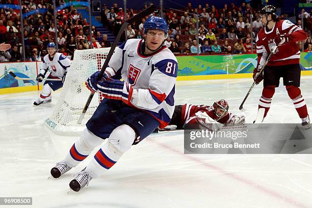 Marian Hossa of Slovakia scores against Edgars Masalskis of Latvia during the ice hockey men's preliminary game between Latvia and Slovakia on day 9...