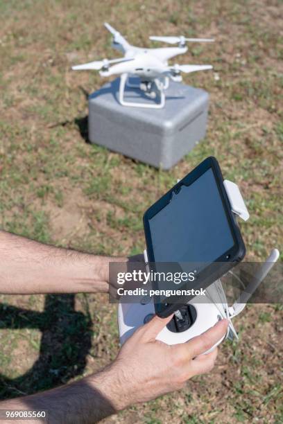 drone operator using a remote control. - pilot joystick stock pictures, royalty-free photos & images
