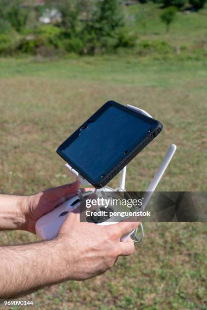 drone operator using a remote control. - pilot joystick stock pictures, royalty-free photos & images