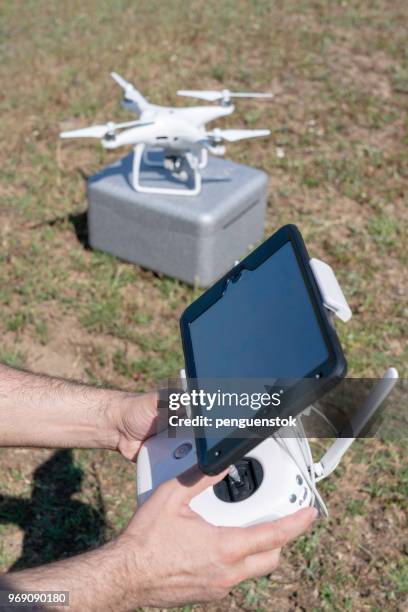 drone operator using a remote control. - pilot joystick stock pictures, royalty-free photos & images