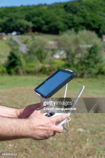 drone operator using a remote control. - pilot joystick stock pictures, royalty-free photos & images