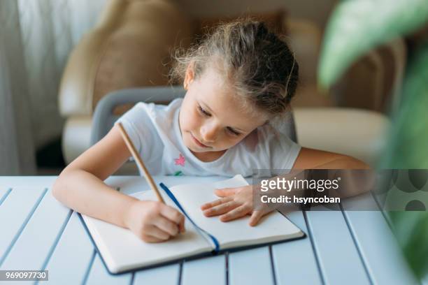 doing homework - workbook stock pictures, royalty-free photos & images