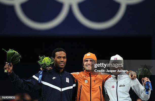 Shani Davis of the United States wins the silver, Mark Tuitert of Netherlands the gold and Havard Bokko of Norway the bronze medal during the flower...